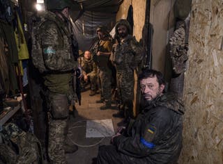 Ukrainian Armed Forces servicemen from the brigade resting inside a shelter at an undisclosed location near the frontline in the Donetsk region